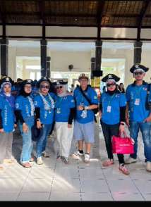 DJW team and travelers in matching blue shirts